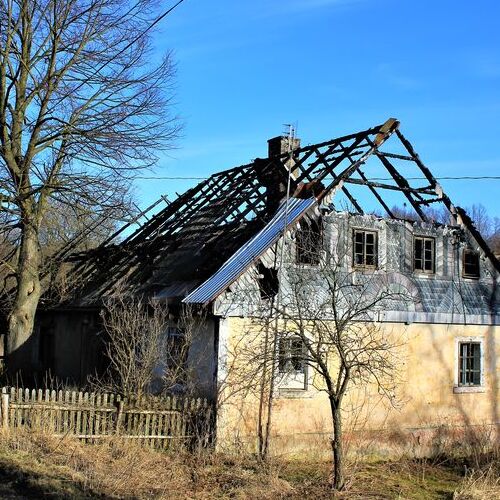 old house with burnt out roof